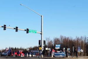 Supporters hold campaign signs at the intersection of Sterling Highway and Kenai Spur Highway on Tuesday, Nov. 3 in Soldotna, Alaska. (Photo by Ashlyn OHara/Peninsula Clarion)