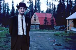 Dr. Elmer Gaede relaxes at home a few weeks after his airplane crash. His facial hair and glasses hide much of his scarring. (Photo courtesy of the Gaede Collection)