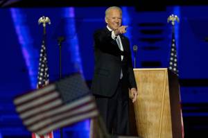 President-elect Joe Biden gestures on stage after speaking, Saturday, Nov. 7, 2020, in Wilmington, Del. (AP Photo/Andrew Harnik, Pool)