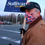 In this Nov. 2, 2020, file photo, Republican U.S. Sen. Dan Sullivan waves a sign at a busy intersection in Anchorage, Alaska. Sen. Sullivan on Wednesday, Nov. 11, 2020, won re-election in Alaska, defeating independent Al Gross. (AP Photo/Mark Thiessen, File)