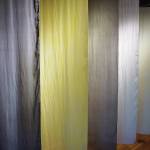 A row of dyed silk wall hangings shows how common Alaska plants found on the lower Kenai Peninsula can be used to make organic dyes, as seen here on Tuesday, Nov. 10, 2020. The hangings are included in Elissa Pettibone's exhibit, "Swatches," showing at Bunnell Street Arts Center in Homer, Alaska. (Photo by Michael Armstrong/Homer News)