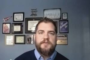 Alaska Department of Health and Social Services Commissioner Adam Crum speaks in a Zoom meeting on Monday, Nov. 16, 2020, in Anchorage, Alaska. (Screen capture)