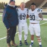 Soldotna High School head football coach Galen Brantley Jr. poses with former players Galen Brantley III and Aaron Faletoi. Brantley III and Faletoi helped Dickinson State in Dickinson, South Dakota, to an undefeated regular season. (Photo provided by Galen Brantley Jr.)