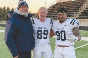 Soldotna High School head football coach Galen Brantley Jr. poses with former players Galen Brantley III and Aaron Faletoi. Brantley III and Faletoi helped Dickinson State in Dickinson, South Dakota, to an undefeated regular season. (Photo provided by Galen Brantley Jr.)