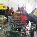 Photo courtesy Kenai Peninsula Food Bank
Kenai Peninsula Food Banks staff and volunteers assemble food bags for the cities of Kenai and Soldotna recently at the food bank, near Soldotna.