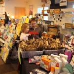 Elizabeth Shaw, left, and Nathaniel Shaw, center, pick out a grab bag in the hopes of winning a free quilt from Karri Ambrosini, right, during the Sterling Fall Festival at the Sterling Community Center on Nov. 28, 2020. (Photo by Brian Mazurek/Peninsula Clarion)
