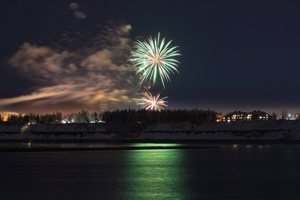 Fireworks can be seen across the Kenai River during the 2020 Christmas Comes to Kenai Parade on Nov. 27, 2020. (Photo courtesy Brittany Brown/Kenai Chamber of Commerce)