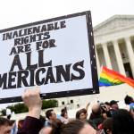 In this Oct. 8, 2019, file photo, protesters gather outside the Supreme Court in Washington where the Supreme Court is hearing arguments in the first case of LGBT rights since the retirement of Supreme Court Justice Anthony Kennedy. As vice president in 2012, Joe Biden endeared himself to many LGBTQ Americans by endorsing same-sex marriage even before his boss, President Barack Obama. Now, as president-elect, Biden is making sweeping promises to LGBTQ activists, proposing to carry out virtually every major proposal on their wish lists. (AP Photo/Susan Walsh, File)