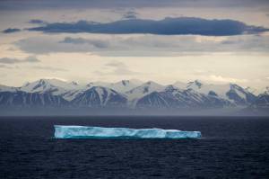 In this July 24, 2017 file photo, an iceberg floats past Bylot Island in the Canadian Arctic Archipelago. The National Oceanic and Atmospheric Administrations annual Arctic Report Card, released on Tuesday, Dec. 8, 2020, shows how warming temperatures in the Arctic are transforming the regions geography and ecosystems. (AP Photo/David Goldman, File)