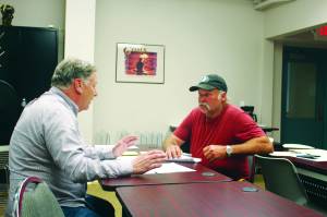 Tim Dillon, executive director of the Kenai Peninsula Economic Development District, helps Doug Weaver, owner of Northern Superior Construction, apply for an AK CARES grant through Credit Union 1 at the KPEDD office in Kenai, Alaska on July 1, 2020. (Photo by Brian Mazurek/Peninsula Clarion)
