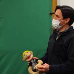 Childrens librarian James Adcox holds a puppet in front of a green screen at the Kenai Community Library on Dec. 11.