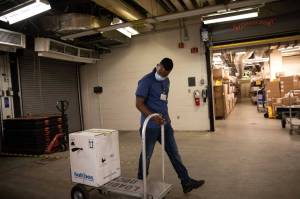 Supply Chain Technician Rebi Abdullahi pulls a box of Pfizers COVID-19 vaccines at Providence Alaska Medical Center on Monday, Dec. 14 in Anchorage, Alaska. (Photo courtesy of DHSS)