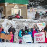 In this photo provided by the Alaska National Guard, residents of the village of Nanwalek, Alaska, greet guardsmen who delivered presents in a CH-47 Chinook helicopter from 1st Battalion, 207th Aviation Regiment, during Operation Santa, Dec. 11, 2020. The Alaska National Guard and the Salvation Army were able to provide and deliver gifts for the programs 65th year, but had to scale back distribution parties that are normally held in the villages because of COVID-19. (Edward Eagerton/U.S. Army National Guard via AP)
