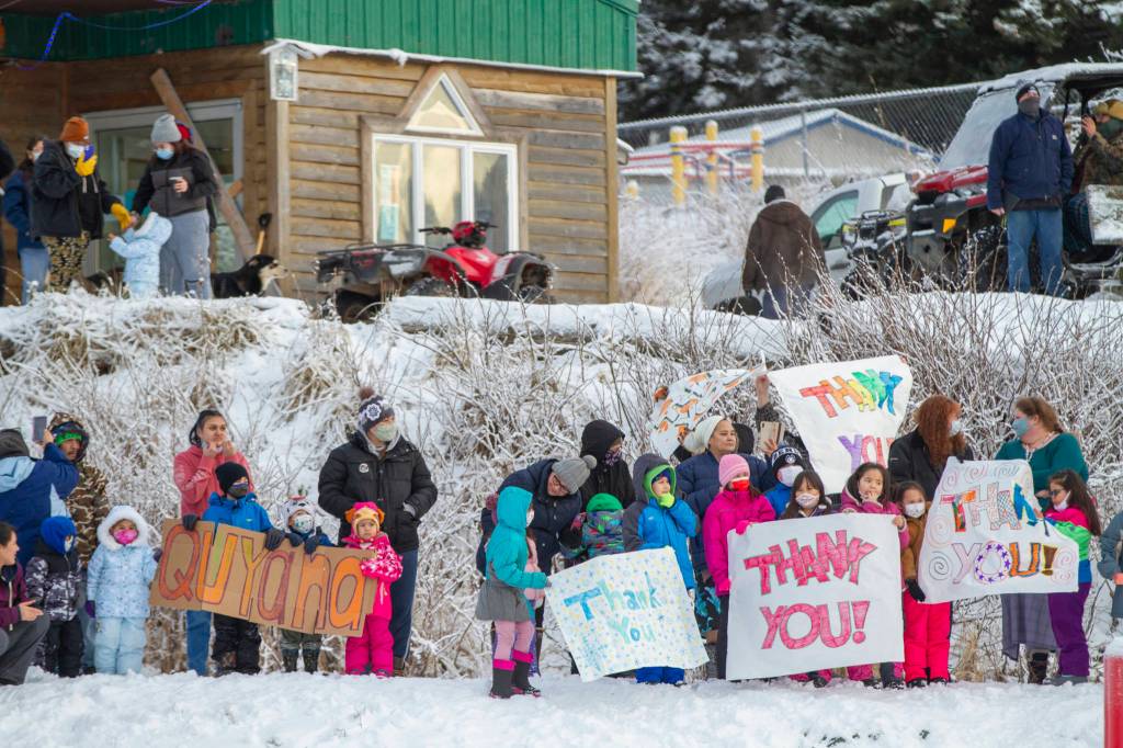 In this photo provided by the Alaska National Guard, residents of the village of Nanwalek, Alaska, greet guardsmen who delivered presents in a CH-47 Chinook helicopter from 1st Battalion, 207th Aviation Regiment, during Operation Santa, Dec. 11, 2020. The Alaska National Guard and the Salvation Army were able to provide and deliver gifts for the programs 65th year, but had to scale back distribution parties that are normally held in the villages because of COVID-19. (Edward Eagerton/U.S. Army National Guard via AP)