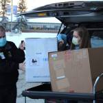 Ronald Lyon (left) and Jessica Hulet (right) unload a box containing doses of Pfizers COVID-19 vaccine at Central Peninsula Hospital on Wednesday, Dec. 16 in Soldotna, Alaska. (Ashlyn OHara/Peninsula Clarion)