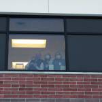 Health care workers wave from inside of Central Peninsula Hospital while awaiting the delivery of the facilitys first shipment of COVID-19 vaccines on Wednesday, Dec. 16, 2020 in Soldotna, Alaska. (Ashlyn OHara/Peninsula Clarion).