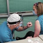 Family practice physician Christina Tuomi, D.O., (right) gets Homer's first dose of Pfizer's COVID-19 vaccine from Emergency Department nurse Steve Hughes (left) on Thursday, Dec. 17, 2020 at South Peninsula Hospital in Homer, Alaska. Tuomi has been the hospital's medical lead throughout the pandemic. (Photo courtesy Derotha Ferraro/South Peninsula Hospital)