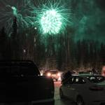 Fireworks are seen above cars at the Soldotna Regional Sports Complex on Friday, Dec. 18 in Soldotna, Alaska. (Ashlyn OHara/Peninsula Clarion)