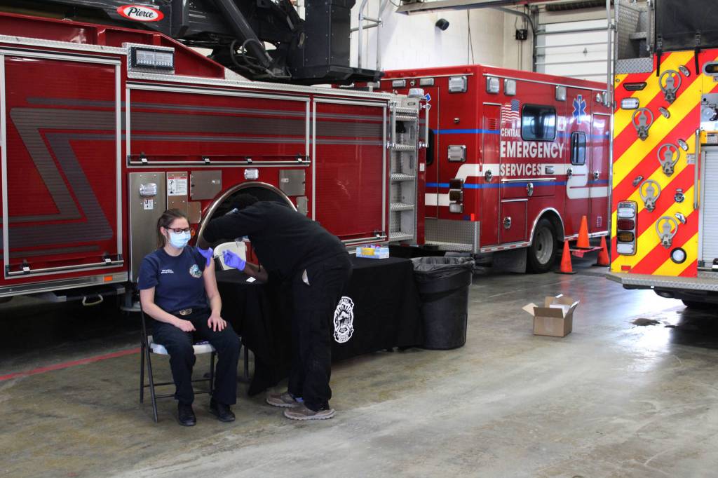 Harrison Deveer (right) administers a dose of Pfizer's COVID-19 vaccine to Brooke Dobson (left) on Friday, Dec. 18, 2020 in Soldotna, Alaska. (Ashlyn O'Hara/Peninsula Clarion)