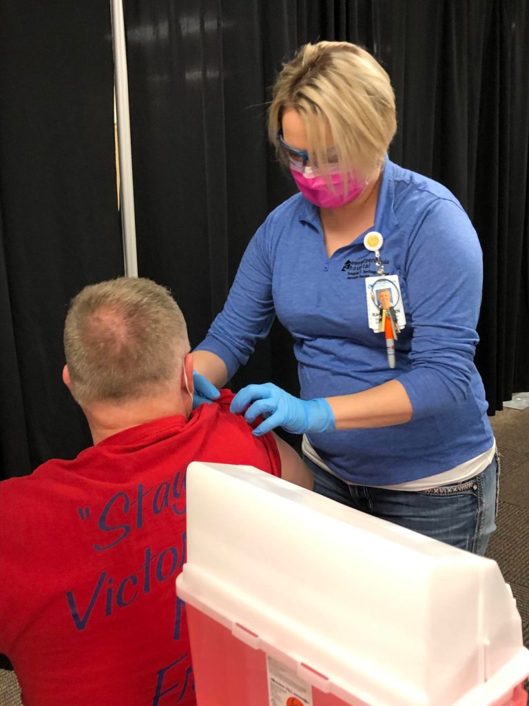RN Rachel Verba (right) administers a dose of Pfizers COVID-19 vaccine to Dr. Chris Michelson (left) on Friday, Dec. 18, 2020 in Soldotna, Alaska. (Photo courtesy Bruce Richards/CPH)