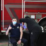 Harrison Deveer (right) administers a dose of Pfizers COVID-19 vaccine to Roy Browning (left) on Friday, Dec. 18 in Soldotna, Alaska. (Ashlyn OHara/Peninsula Clarion)