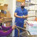 Bjorn Miller, Pharm D (right) and Vallerie Card-King, L. CPht, (left) document and verify the batch numbers of the Moderna Vaccine at the Alaska VA Healthcare System. (Photo courtesy of Alaska VA Healthcare System)