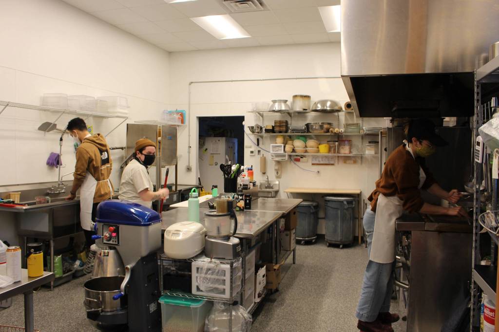 Brian Mazurek/Peninsula Clarion 
From left, Trevor Bagley, Beau Pearston and Adren Setian close down the kitchen at Lucys Market in Soldotna on Saturday.
