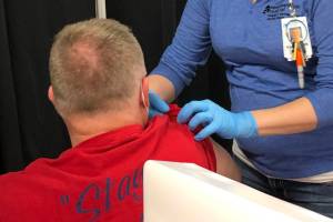 RN Rachel Verba (right) administers a dose of Pfizers COVID-19 vaccine to Dr. Chris Michelson (left) on Friday, Dec. 18, 2020 in Soldotna, Alaska. (Photo courtesy Bruce Richards/CPH)