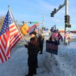 Ron Henry holds an American flag at the intersection of Kenai Spur and Sterling highways on Wednesday, Jan. 6 in Soldotna, Alaska. (Ashlyn OHara/Peninsula Clarion)