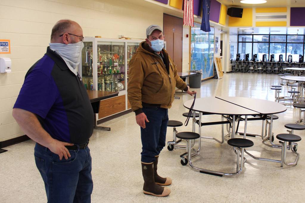 Vaughn Dosko (left) and Mike Tilly (right) discuss COVID-19 mitigation in the lunchroom at Kenai Middle School on Friday, Jan. 8 in Kenai, Alaska. (Ashlyn OHara/Peninsula Clarion)