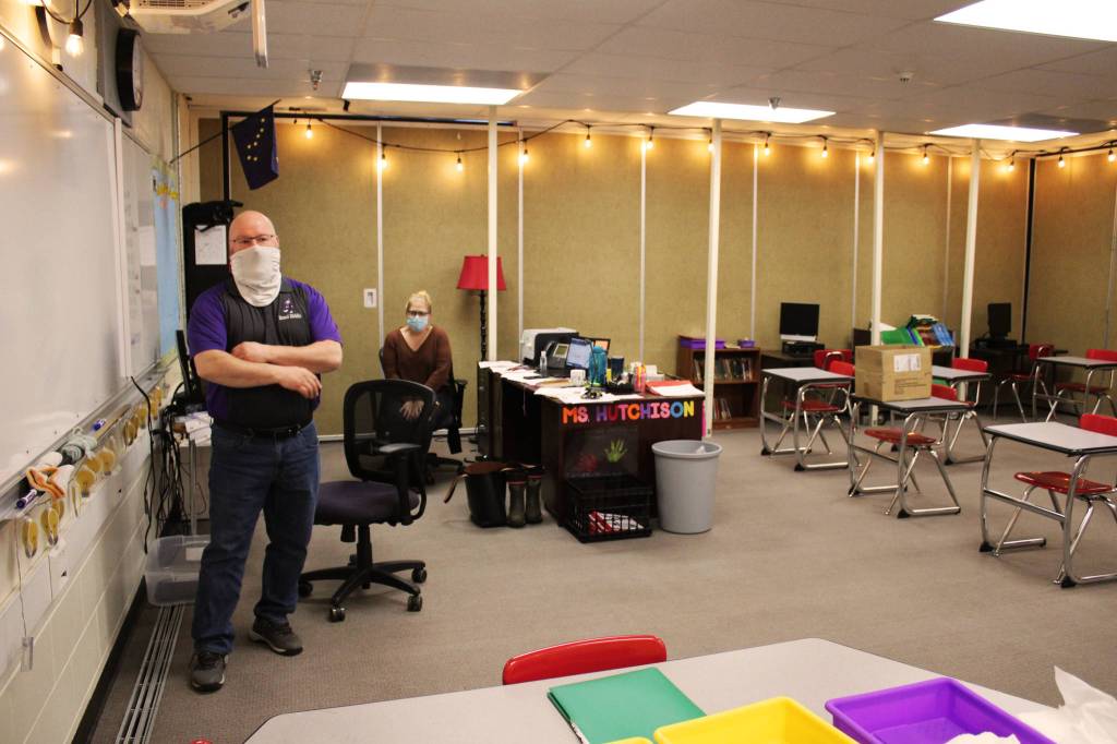 Vaughn Dosko (left) and Sarah Hutchison discuss COVID-19 mitigation in Hutchison's classroom at Kenai Middle School on Friday, Jan. 8 in Kenai, Alaska. (Ashlyn O'Hara/Peninsula Clarion)