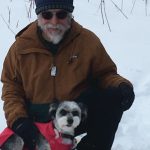 Michael Armstrong and his dog, Fletcher, take a break from snowshoeing on Dec. 13, 2020, on Diamond Ridge near Homer, Alaska. (Photo by Jenny Stroyeck)