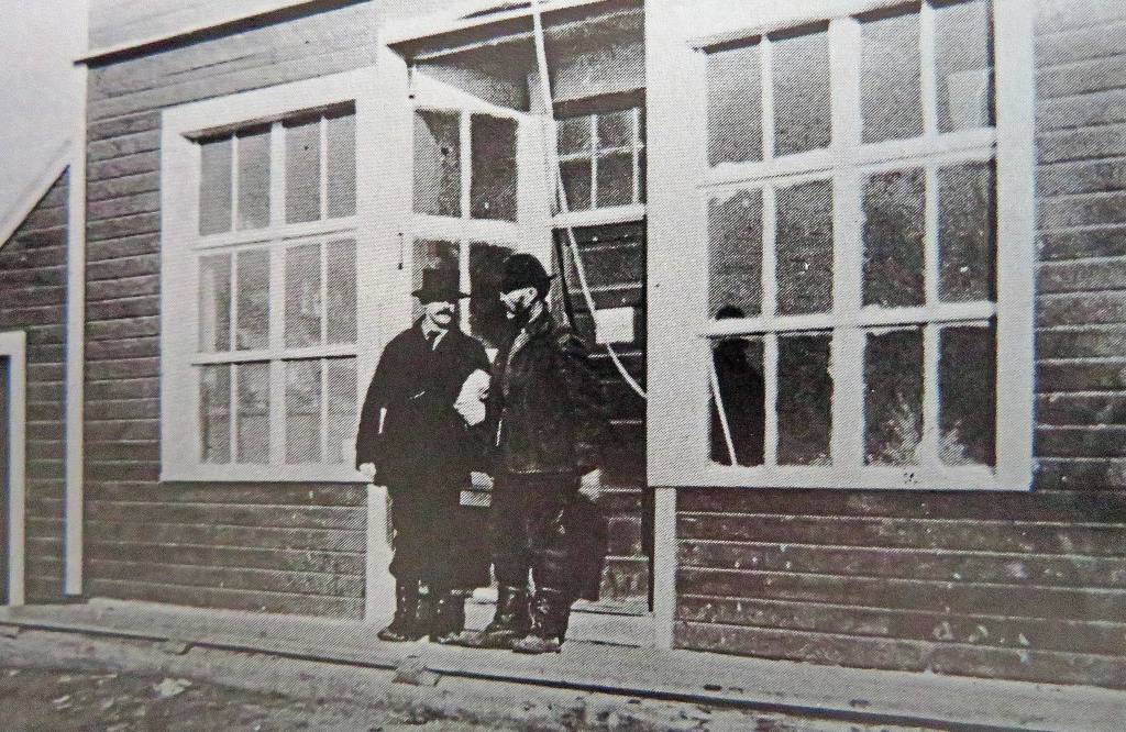 William N. Dawson chats with Captain Rose, of the S.S. Tyonic, in front of Dawson’s Kenai store in 1915. (Photo from "Once Upon the Kenai")