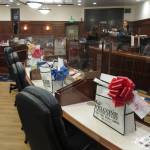 Welcome bags and plexiglass dividers placed around their desks await lawmakers on the Alaska House floor in Juneau, Alaska, Monday, Jan. 18, 2021. The committee was among several that had scheduled meetings Monday, the last day before the new Legislature is set to convene on Tuesday, Jan. 19. (AP Photo/Becky Bohrer)