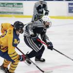 Soldotnas Aiden Burcham controls the puck under pressure from Homers Brock Barth during a Saturday, Jan. 23, 2021 hockey game between the two schools at Kevin Bell Arena in Homer, Alaska. (Photo by Megan Pacer/Homer News)