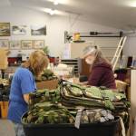 Volunteers Kathy Gensel, Mary Bell and Sherry Martinovich fill backpacks with supplies for the upcoming Project Homeless Connect event at Love, INC in Soldotna, Alaska on Jan. 22, 2021. (Photo by Brian Mazurek/Peninsula Clarion)