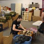 Volunter Emily Alvey looks through the backpacks that will be filled with supplies for the upcoming Project Homeless Connect Event at Love, INC. in Soldotna, Alaska on Jan. 22, 2021. (Photo by Brian Mazurek/Peninsula Clarion)