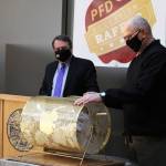 Ben Hohenstatt / Juneau Empire
State Sen. Click Bishop (right) prepares to draw a name from the barrel Wednesday during the second annual Permanent Fund Dividend Education Raffle while Department of Revenue deputy commissioner Mike Barnhill watches in the State Office Building.