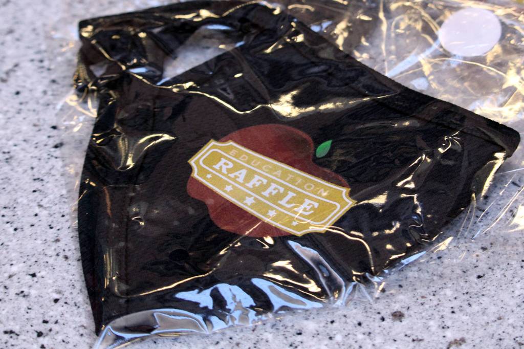 A PFD Education Raffle face mask sits a top a table in the State Office Building on Wednesday, Jan. 28, 2021. (Ben Hohenstatt / Juneau Empire)