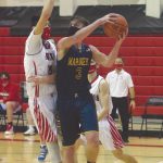 Kenai Centrals Jordan Kvasnikoff defends Homers Clayton Beachy on Thursday, Jan. 28, 2021, at Kenai Central High School in Kenai, Alaska. (Photo by Jeff Helminiak/Peninsula Clarion)