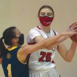 Homers Sailey Rhodes defends Kenai Centrals Erin Koziczkowski on Thursday, Jan. 28, 2021, at Kenai Central High School in Kenai, Alaska. (Photo by Jeff Helminiak/Peninsula Clarion)