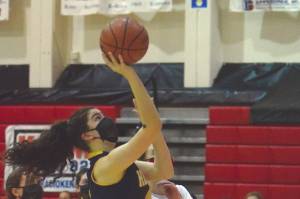 Homer's Delilah Harris goes up for a shot against Kenai Central's Erin Koziczkowski on Thursday, Jan. 28, 2021, at Kenai Central High School in Kenai, Alaska. (Photo by Jeff Helminiak/Peninsula Clarion)