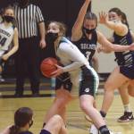 Nikiskis Lillian Carstens drives to the basket while Soldotnas Rhys Cannava defends Saturday at Nikiski High School in Nikiski. (Photo by Jeff Helminiak/Peninsula Clarion)