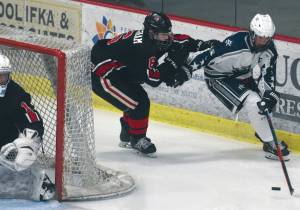 Kenai Central's Gavin Langham defends Soldotna's Dylan Walton while Kenai goalie Tommy Baker watches Friday, Jan. 29, 2021, at the Soldotna Regional Sports Complex in Soldotna, Alaska. (Photo by Jeff Helminiak/Peninsula Clarion)