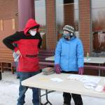 Dale Curtis, left, speaks with volunteer Heather Schaefer, right, during a Project Homeless Connect event at the Sterling Senior Citizens Center in Sterling, Alaska, on Feb. 2, 2021. (Photo by Brian Mazurek/Peninsula Clarion)