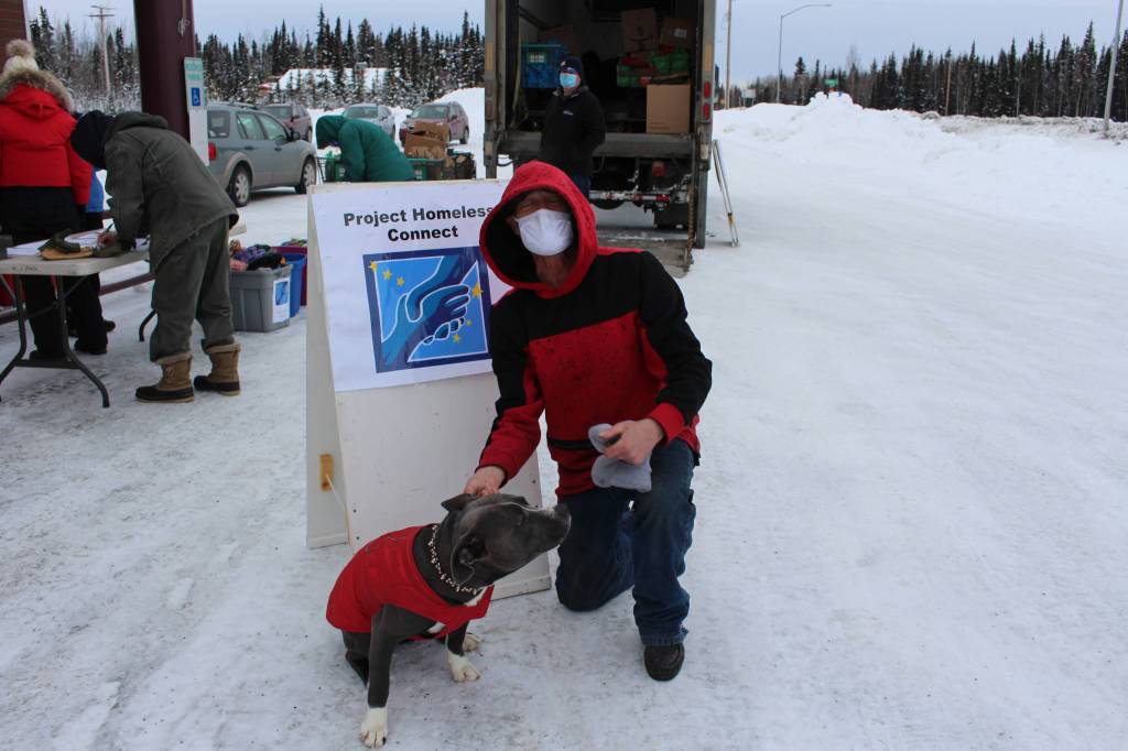 Dale Curtis poses for a photo with his dog, Jackson, during a Project Homeless Connect event at the Sterling Senior Citizens Center in Sterling, Alaska, on Feb. 2, 2021. (Photo by Brian Mazurek/Peninsula Clarion)