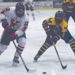 Kenai Central's Landen Cialek attacks the net with Homer's Fiona Hatton defending Tuesday, Feb. 2, 2021, at the Kenai Multi-Purpose Facility in Kenai, Alaska. (Photo by Jeff Helminiak/Peninsula Clarion)