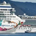 A fishing vessel is drawfed by the Norwegian Cruise Lines' Norwegian Jewel and Norwegian Pearl in Juneau's downtown harbor in September 2014. On Thursday, Canada announced a ban on cruise vessels in Canadian waters through February 2022. (Michael Penn / Juneau Empire File)