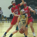 Nikiskis Avery White shoots under pressure from Kenai Centrals Erin Koziczkowski and Amber Nash on Thursday, Feb. 4, 2021, at Nikiski High School in Nikiski, Alaska. (Photo by Jeff Helminiak/Peninsula Clarion)
