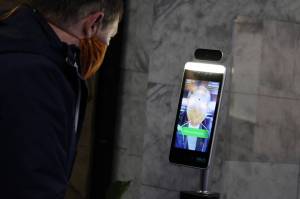 State Sen. Jesse Kiehl, D-Juneau, has his temperature taken inside the Alaska State Capitol on Jan. 19, 2021. The high tech check-ins have become routine over the past few weeks. (Ben Hohenstatt / Juneau Empire)